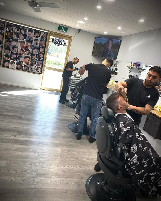 Busy day at Barberz Den with multiple barbers working