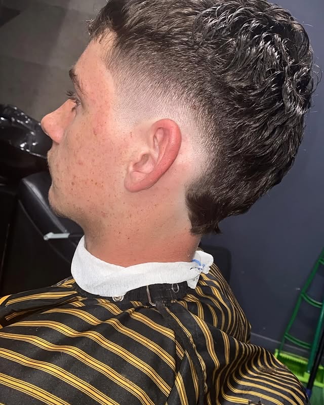 Curly top with a clean burst fade finish